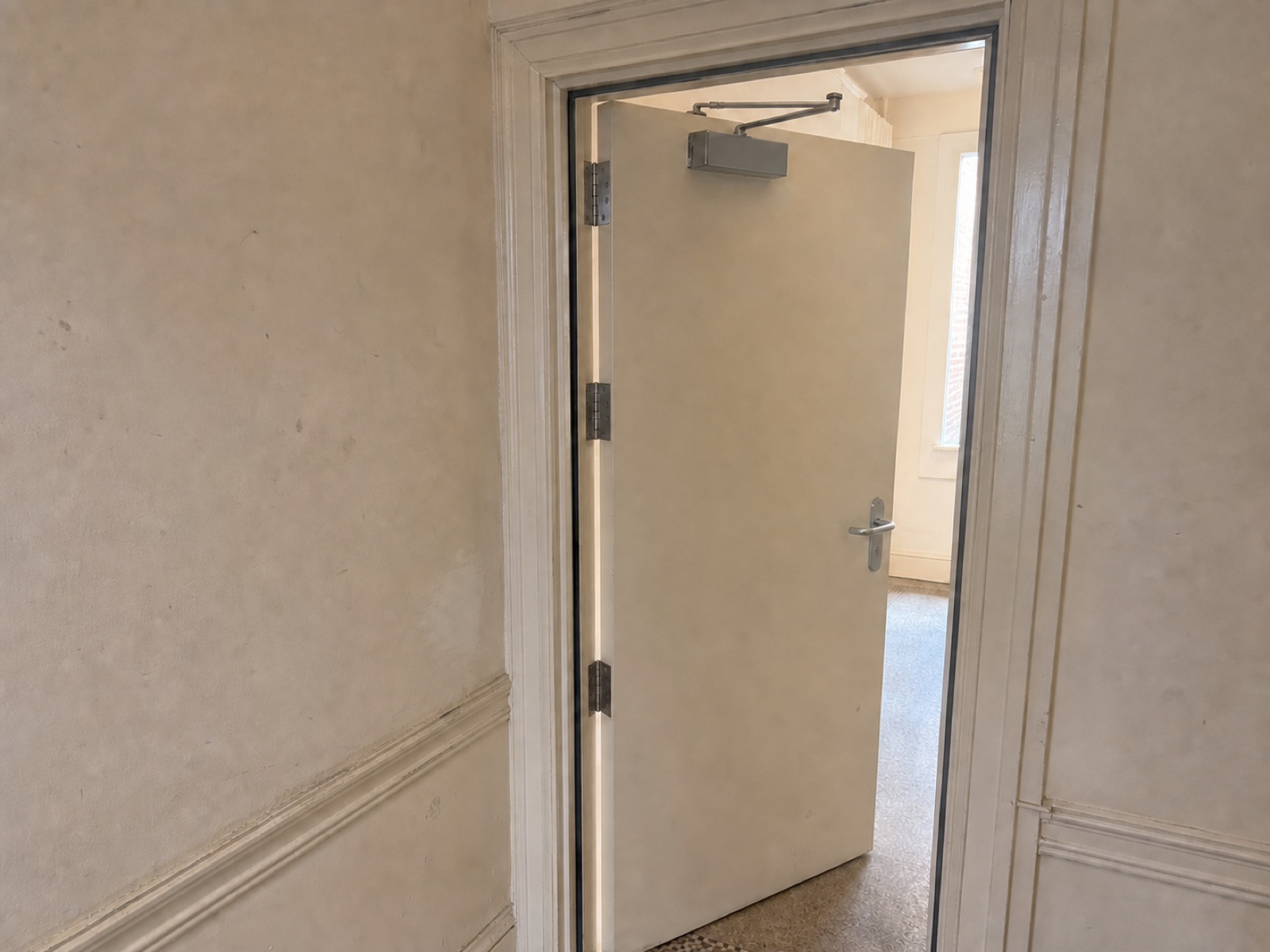 AI-generated illustrative image of fire-door remedial work showing hinges, smoke seals and an overhead door closer.